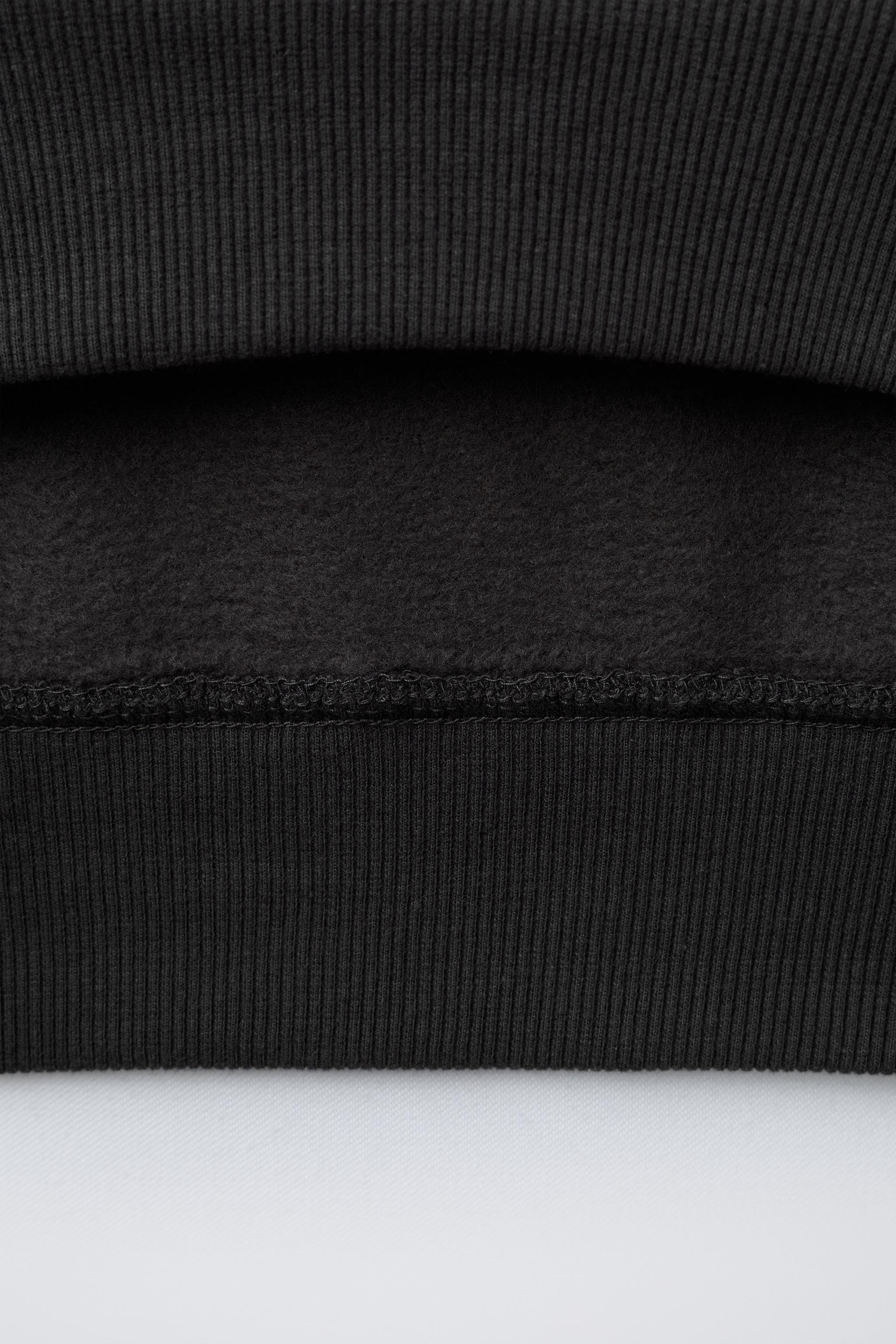 RAISED TEXT SWEATSHIRT